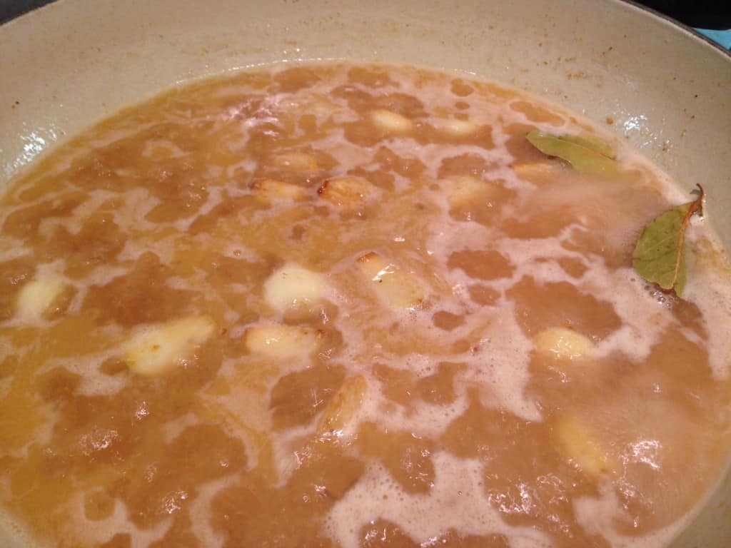 Simmering vinegar and chicken stock.