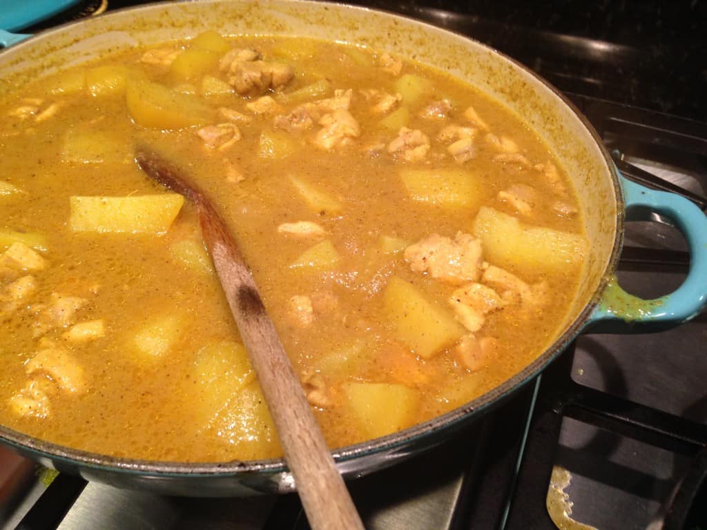 Chicken vindaloo simmering on stove.