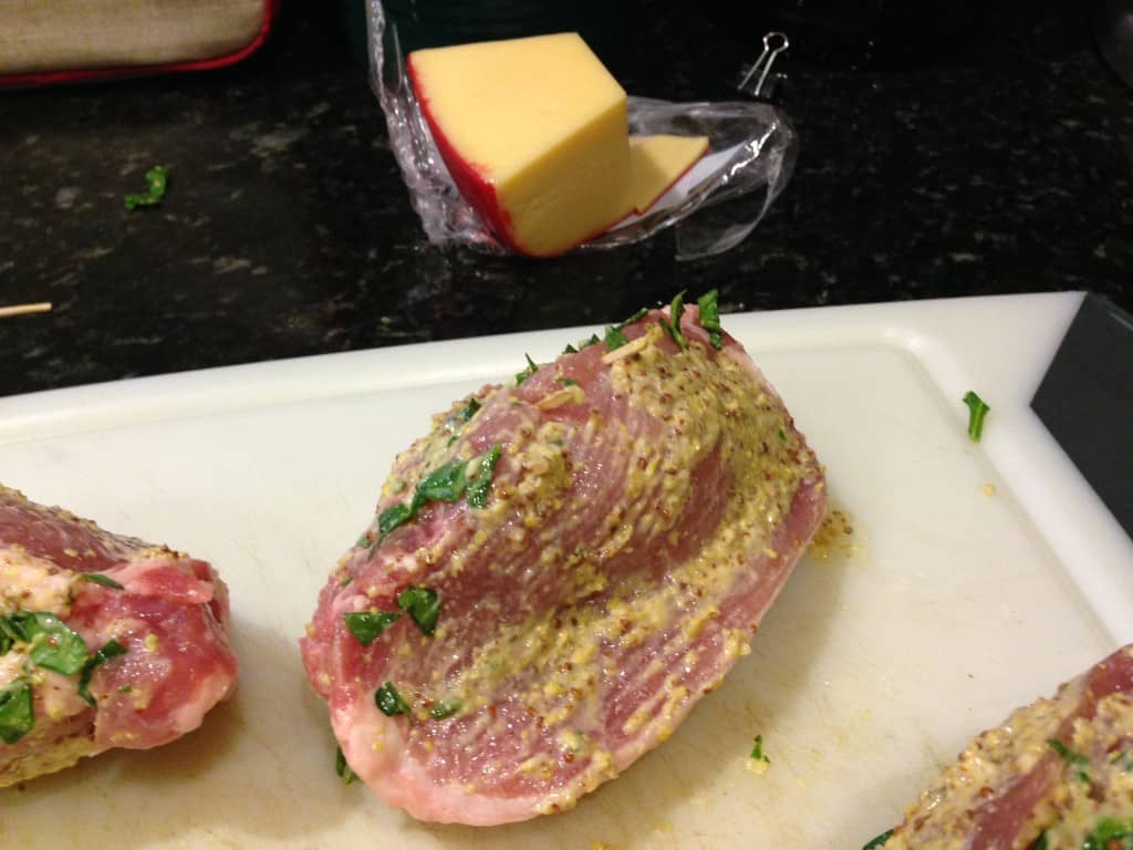 Coating the pork chops in mustard prior to breading them