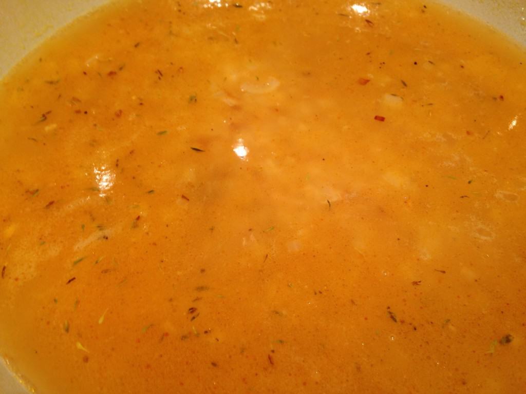 After the rice is browned, add the spice and chicken stock