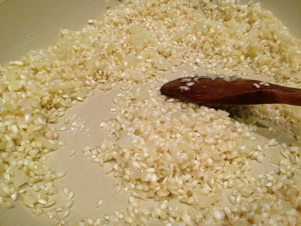 Sauteeing rice in onions and olive oil.